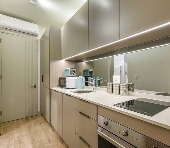 Spacious kitchen corner in a luxury studio apartment in Johannesburg with modern appliances.